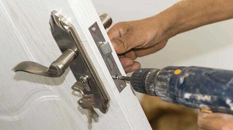 Person installing a door lock.