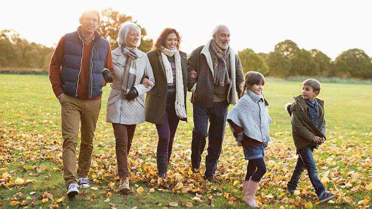 A multigenerational family walking outside.