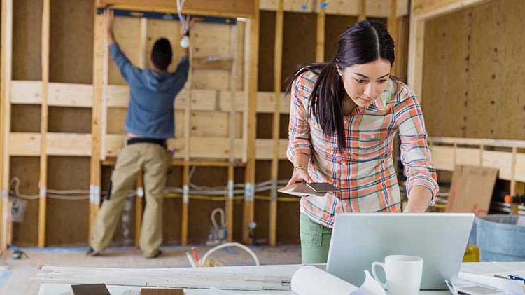 Couple putting up walls in a house.