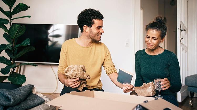 Man and woman packing moving boxes.